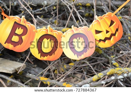 inscription BOO wording with Self Made hand drown Smiley face Halloween. orange and yellow on the forest background.