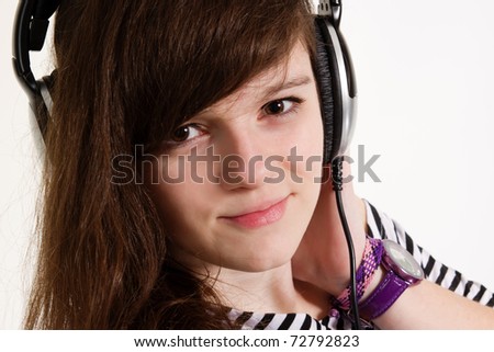 Teenager disc jockey chick in big dynamic headphones posing