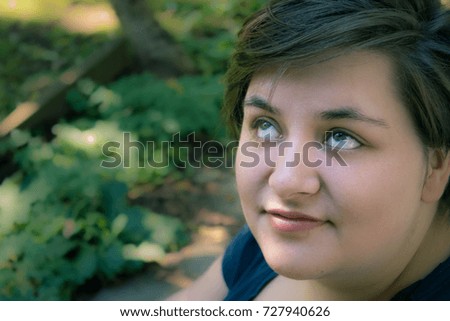 girl in garden rolling eyes 