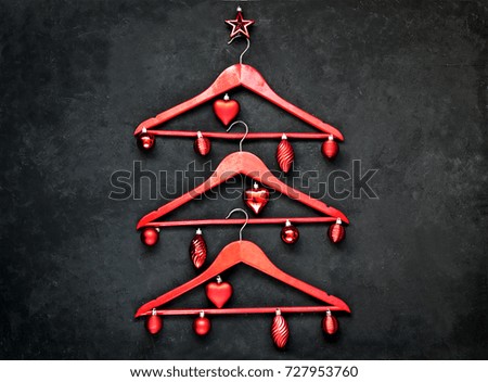 Red hanger on a black background. Seasonal sale a place for a label
