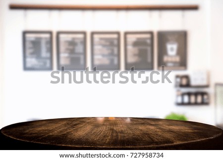 Empty wooden table and blur background of abstract in front of restaurant or coffee shop, cafe  can be used Mock up for display of product or for montage.