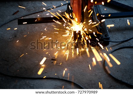 Worker cutting metal with grinder