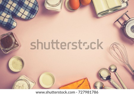 Baking ingredients and equipment with pink pastel background.