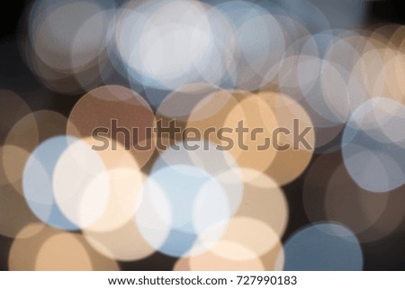 Abstract of lights blurred bokeh background from night life party in vintage or retro color toned.
