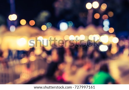 Abstract blur image of Night market on street for background usage. (vintage tone)