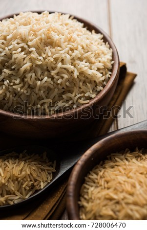 Stock photo of Indian brown wholegrain basmati Rice in cooked and raw form, served in a bowl. selective focus
