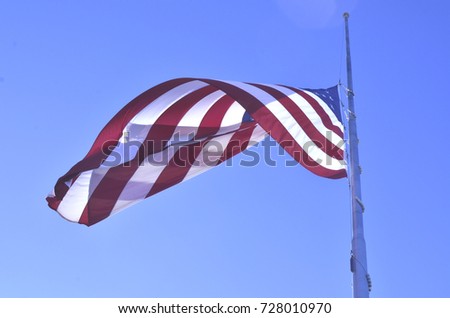 American flag flying at half staff or half mast