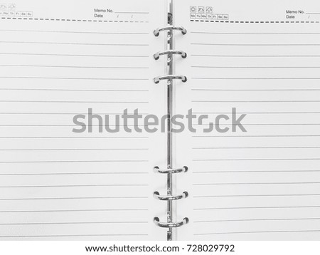 Top view of spiral blank notebook with pencil