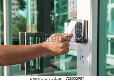 Hand using security key card scanning to open the door to entering private building. Home and building security system Royalty-Free Stock Photo #728032987