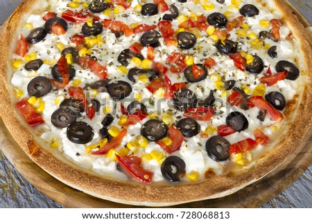 Italian Delicious Fresh Hot Mix Baked Vegan Pizza with Melting Mozzarella Cheese, hot spicy green pepper, mushroom, cube cut tomato, corn and black olive oil serving on grey textured rustic background