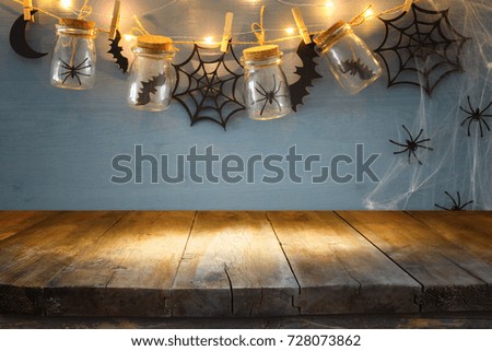 Halloween holiday background with empty rustic table. Ready for product display montage.