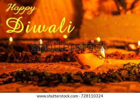 Happy Diwali Diya flame on glass of water on diwali festival of lights Royalty-Free Stock Photo #728110324
