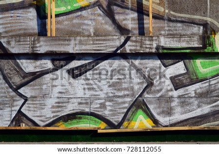Concrete weathered worn wall damaged paint. Grungy Concrete Surface with graffiti colors and outlines. Street art background texture. Close up painted wall of the city