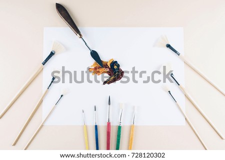Multicolor oil paint brush strokes with knife on white background. Flat lay style. Art and  education concept.