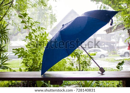 Umbrella On a wooden desk  On rainy day