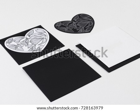 Black white and gray color mock-up of stationery, a template for identification on a gray and white background. For presentations and portfolio of graphic designers. Envelopes, sheets of paper, hearts