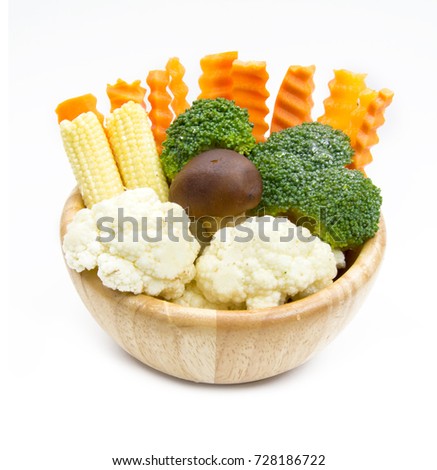 mixed vegetables in wooden bowl on white background