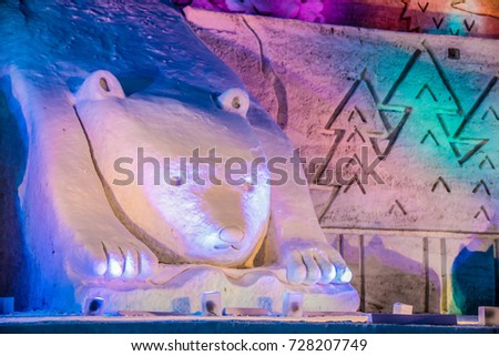 Soft focus of big bear with colorful lights in the public park in snow festival.Snow sculptures in winter season, Japan.