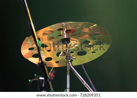 A closeup of drum plate standing on a green illuminated stage
