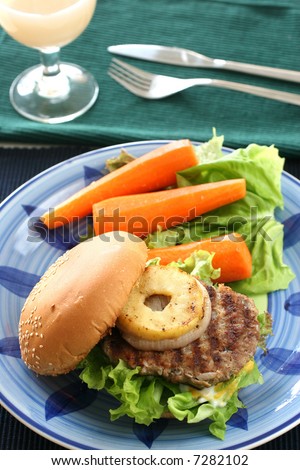 Healthier homemade grilled burger with carrots and plenty vegetables