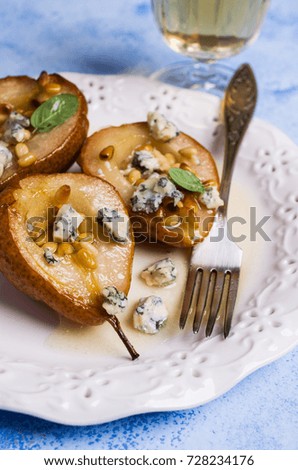 Baked pears with nuts and blue cheese. Selective focus.