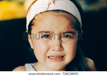 Closeup portrait of Little mixed race girl crying 
