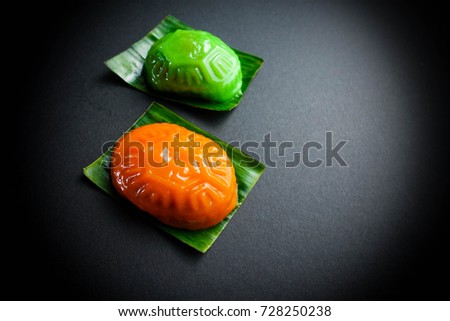 Ang Ku Kueh or Red tortoise cake with green color, Malaysian Chinese snack in black background