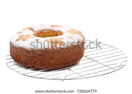 homemade traditional fruit cake on metal stand isolated on white background