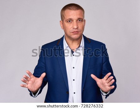 businessman in blue suit isolated on grey background