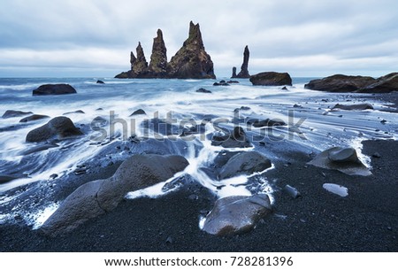 Iceland, Jokulsarlon lagoon, Beautiful cold landscape picture of icelandic glacier lagoon bay, The Rock Troll Toes. Reynisdrangar cliffs. Black sand beach.