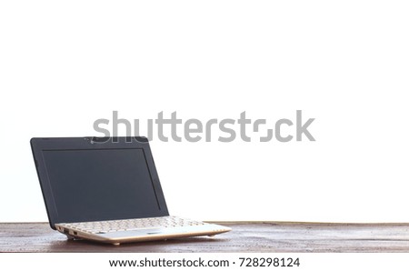 Laptop stands on a wooden table on white background