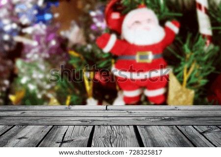 rustic wood table in soft focus of snowman,christmas tree background