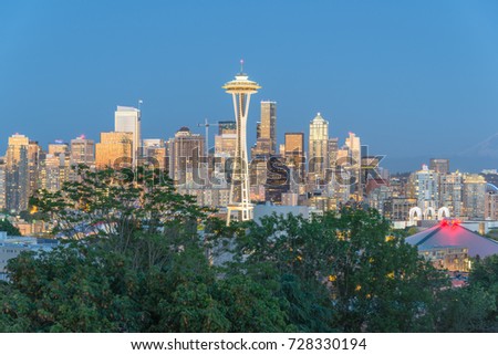 Seattle downtown skylines, urban office buildings with Mt Rainier at blue hour as seen from Kerry Park.