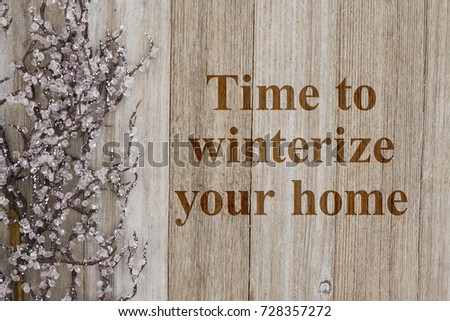 Time to winterize your home text with a iced tree branch on weathered wood Royalty-Free Stock Photo #728357272