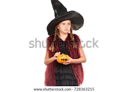 Portrait of little girl with braids posing in Halloween costume against white background
