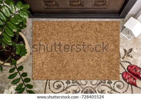 Blank doormat before the door in the hall. Mat on ceramic floor, flowers and red shoes. Welcome home, product Mockup Royalty-Free Stock Photo #728405524