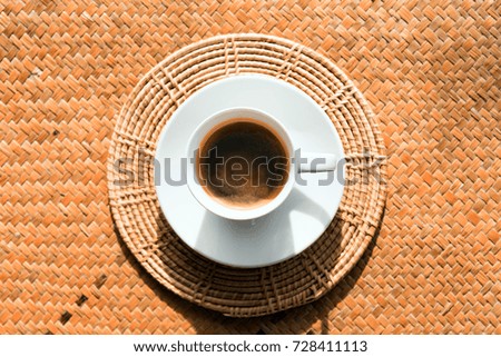 Coffee in white coffee cups placed on natural basketry.