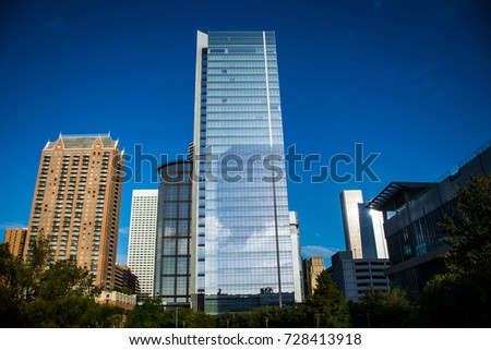 New modern skyscraper downtown Houston Texas skyline cityscape view looking up at high tower with blue sky nice morning sun