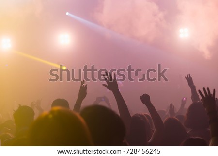Silhouette hands of audience crowd people use smart phones enjoying the club party with concert. Celebrate new year party , Blurry people movement enjoy of music. Abstract Background.