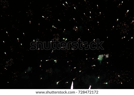A photo of a salute in the night sky. Bright texture of festive fireworks. Abstract holiday background with various colors fireworks light. New Year's, Christmas lights in the sky, colorful lights.