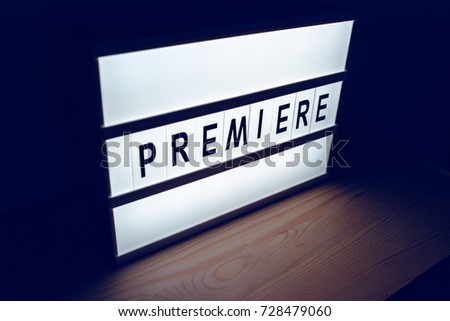 Vintage illuminated lightbox Premiere sign in cinema movie or for radio and television live audience broadcast