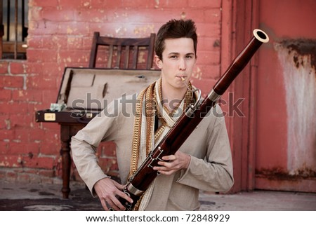 Handsome young Caucasian man in Indian attire plays a Bassoon Royalty-Free Stock Photo #72848929