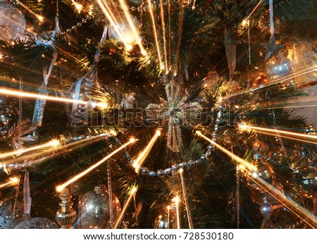 Abstract Cross Ornament on Christmas Tree with Light Rays Close Up