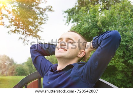 young man resting in the Park, back of the hands, copy space, background