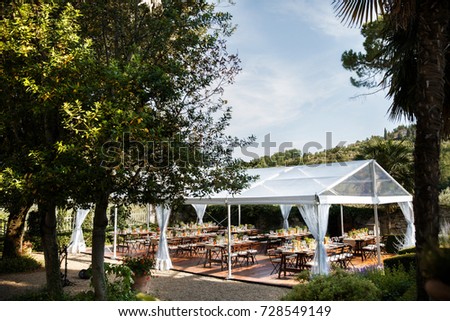 Tables sets for wedding or another catered event dinner. Courtyard of an Italian villa. Villa Bordoni Royalty-Free Stock Photo #728549149