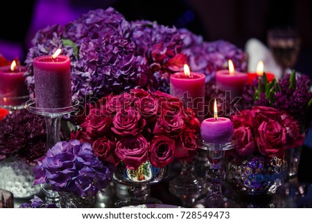 Candle and beautiful flowers on the wedding table. Royalty-Free Stock Photo #728549473
