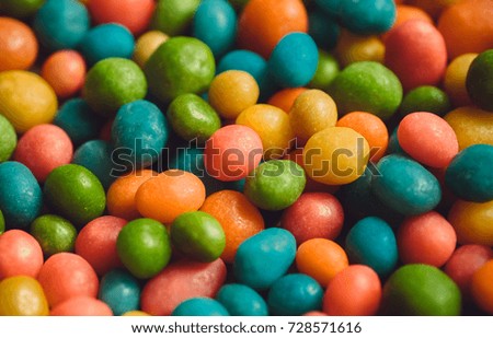 Sugar candy decoration background. Heap of crazy colors candies with small green, yellow, blue sweets.