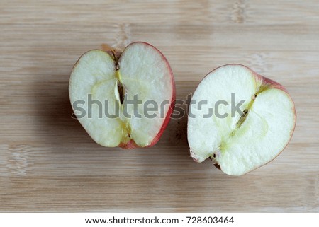 Red apples on wooden background.