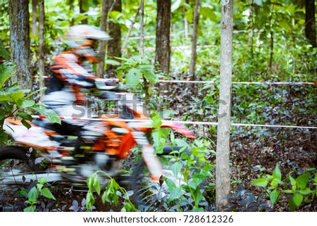 Fast motion of mountain bikes racing in jungle in day time. Concept of focus during an accelerate in action sport