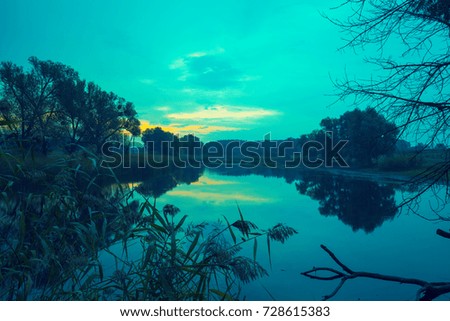 Early morning, the time before dawn. Sunrise over lake. Rural landscape, wilderness.
